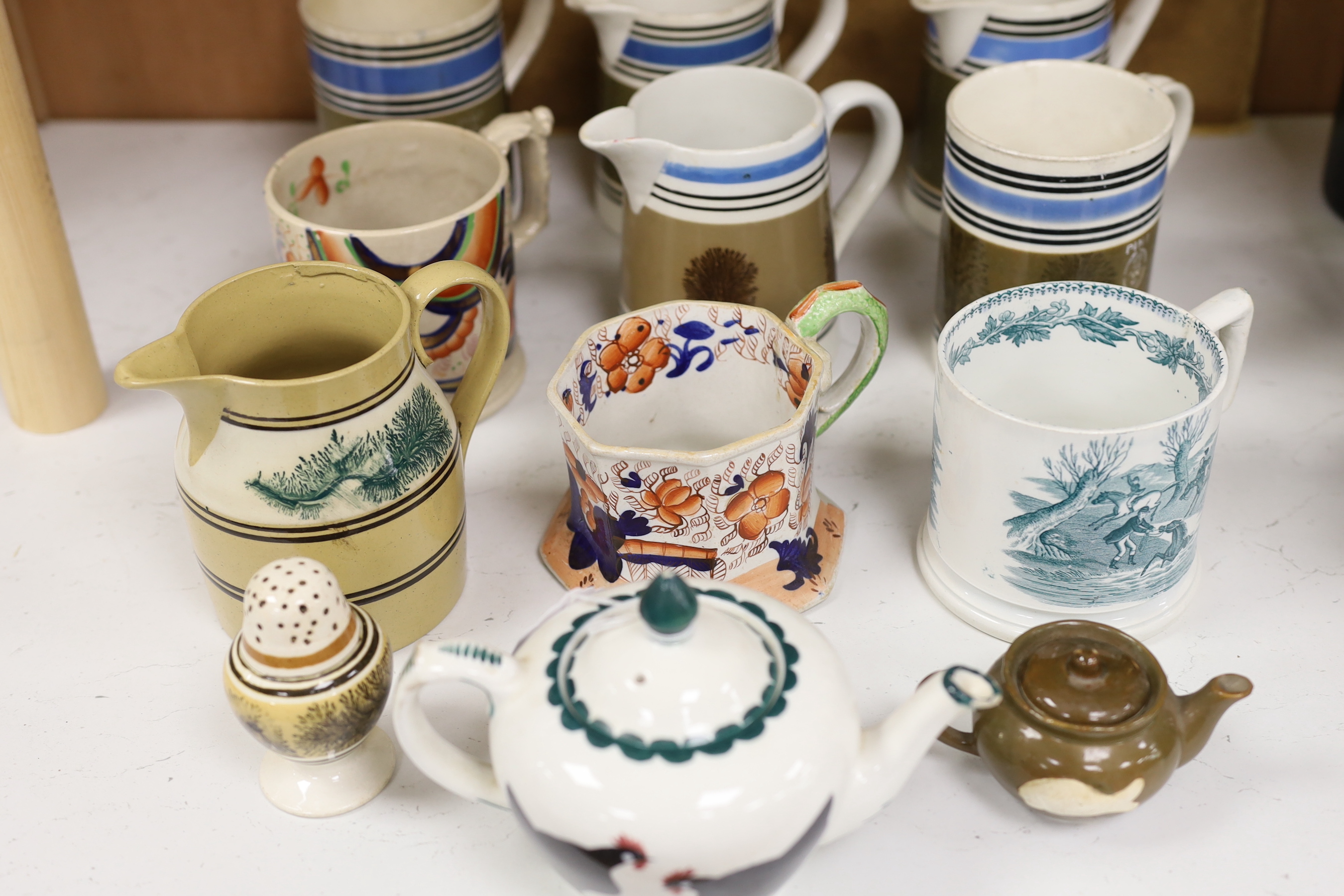 A group of Mocha ware, three various earthenware mugs, a Wemyss-style teapot, etc. (12)